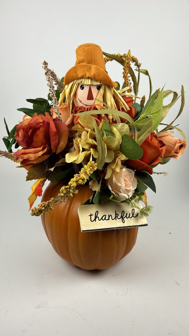 Centerpiece A fall colored centerpiece in a round vase.