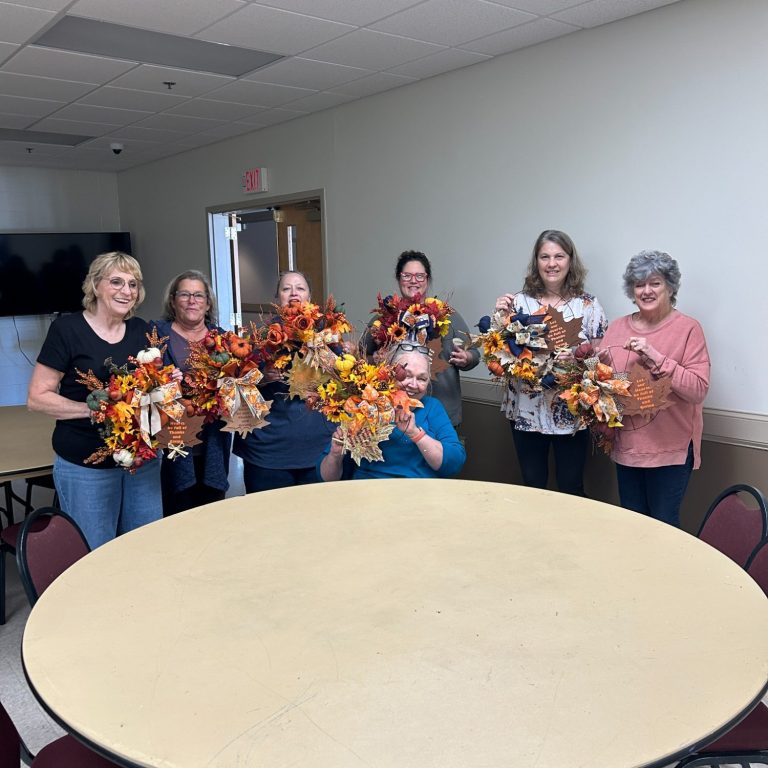 Workshop Class Attendees A group of six women holding wreaths the designed during a workshop.