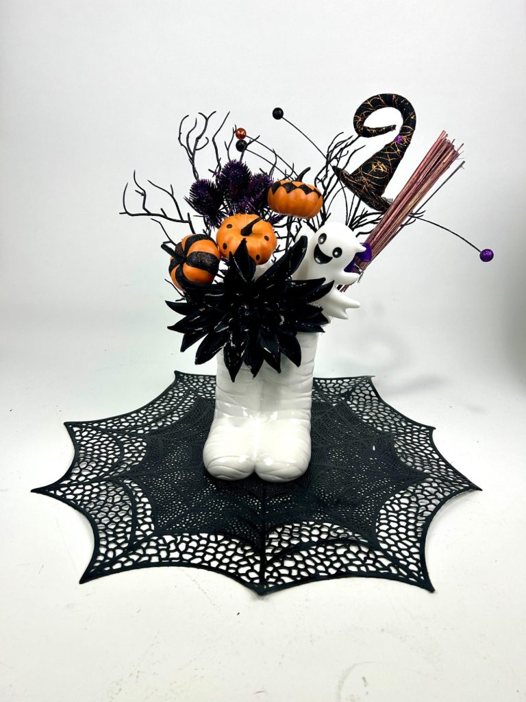 Halloween Centerpiece A Halloween themed centerpiece in orange and black on a web shaped black mat.