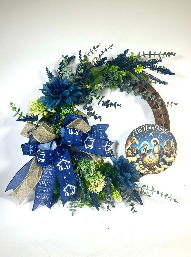 Decorative Wreath A grapevine wreath decorated with greenery and blue and white flowers.